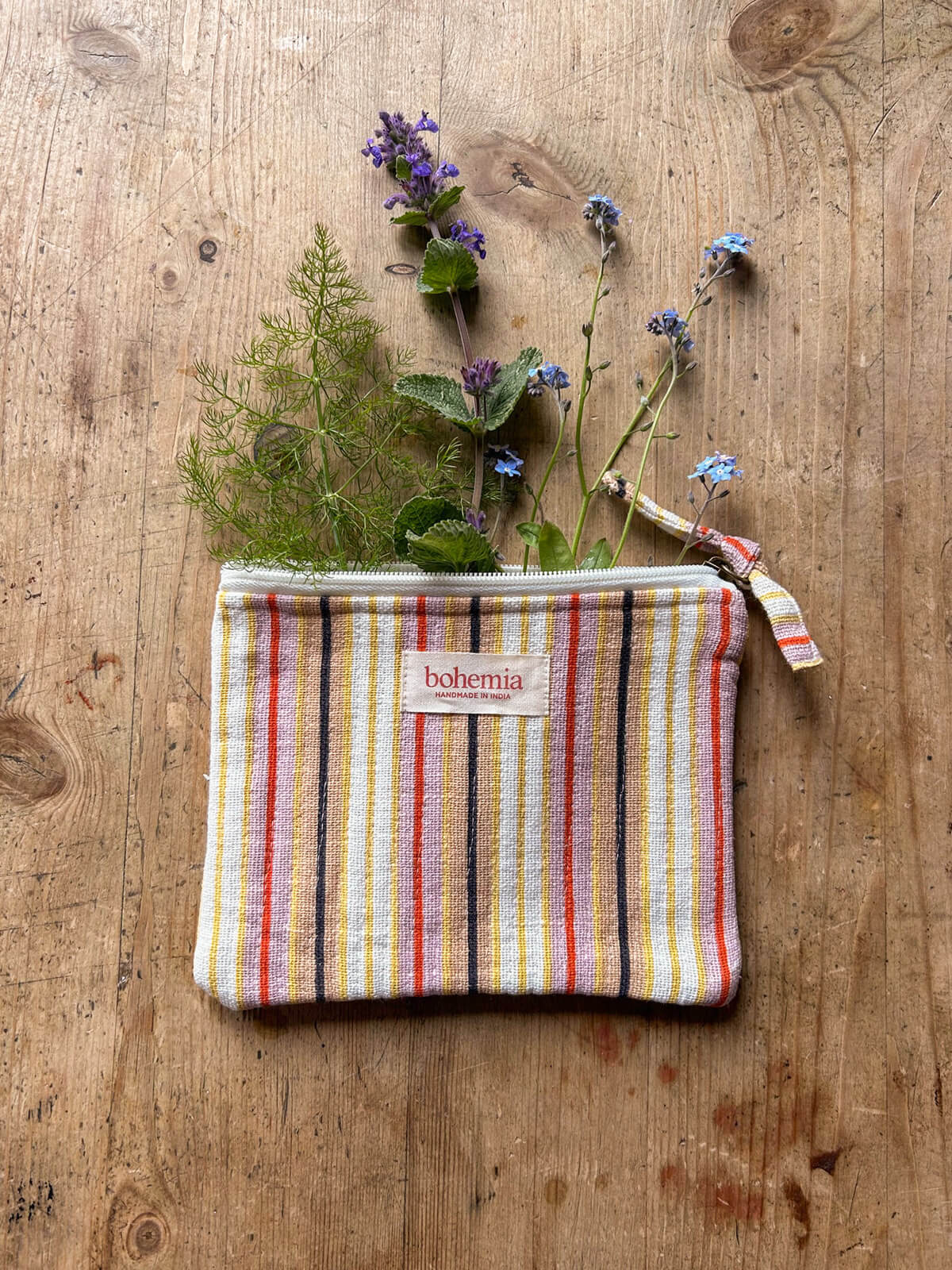 Stripe quilted cotton accessory bag styled with fresh garden flowers on rustic wooden table by Bohemia Design