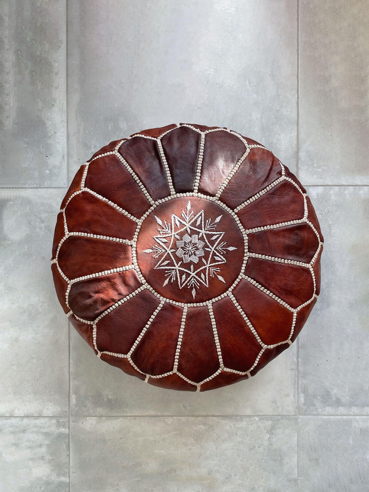 Chestnut brown Moroccan leather pouffe with hand embroidered design on the top