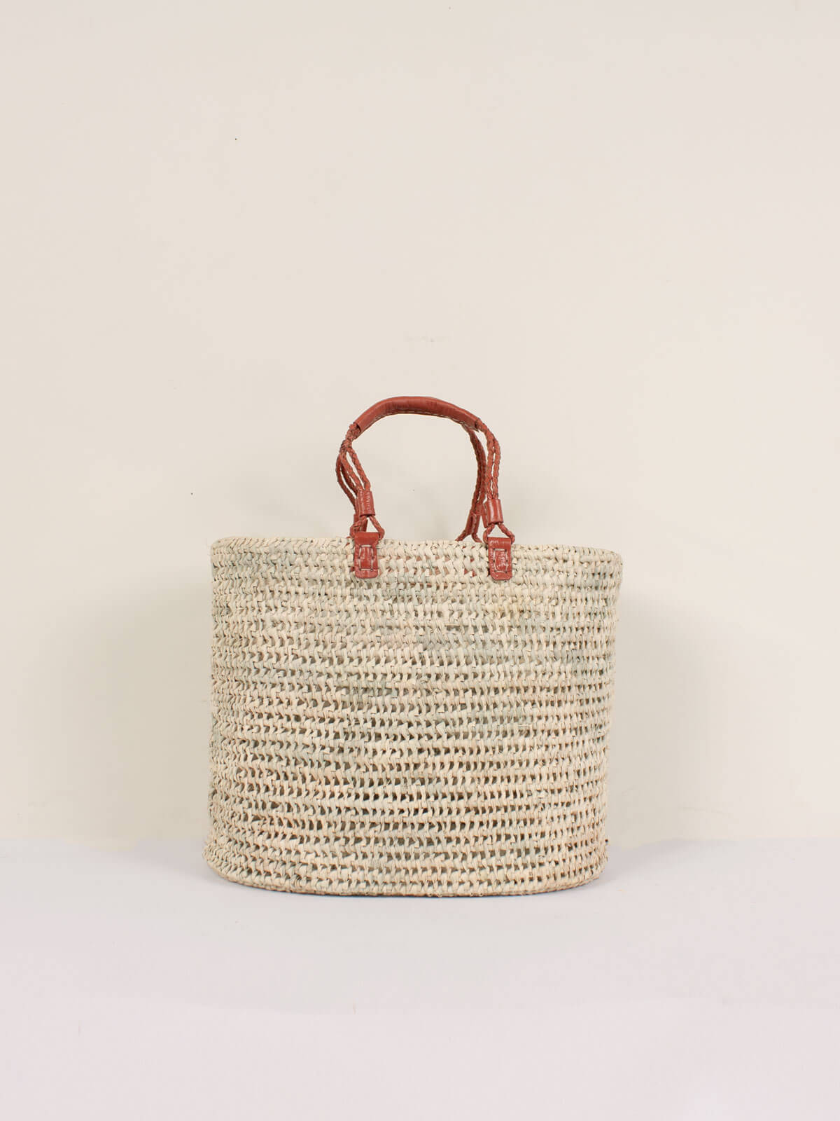 Large open weave natural basket with terracotta pleated leather handles