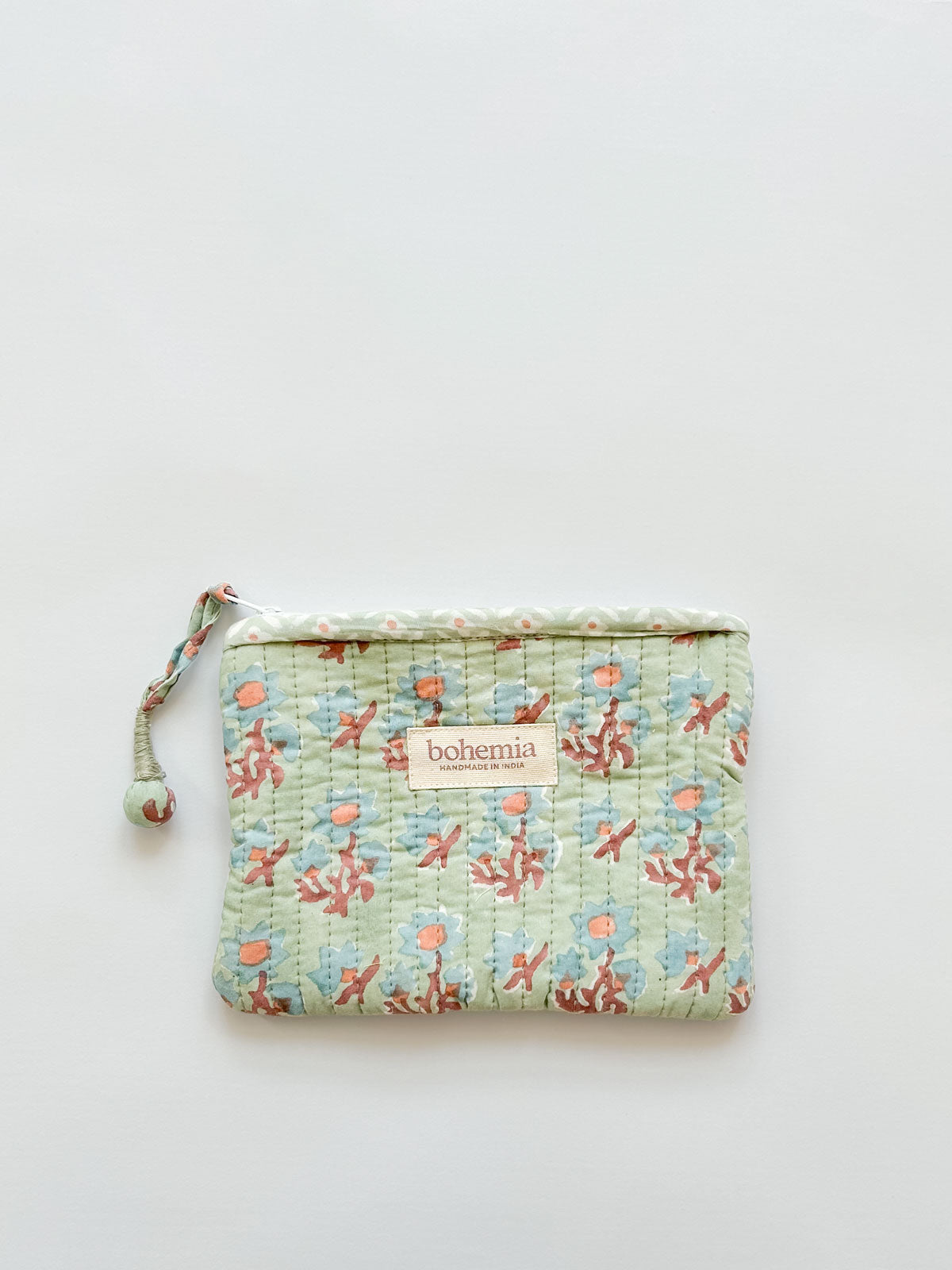 A medium size quilted zip pouch in soft green-blue and terracotta with a handcrafted zip pull | Bohemia